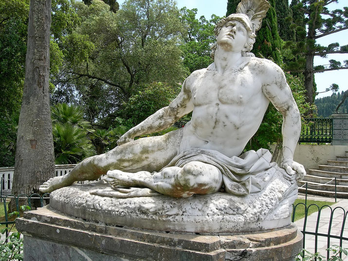 A marble statue of a dying warrior, possibly Achilles, reclining with a pained expression. 