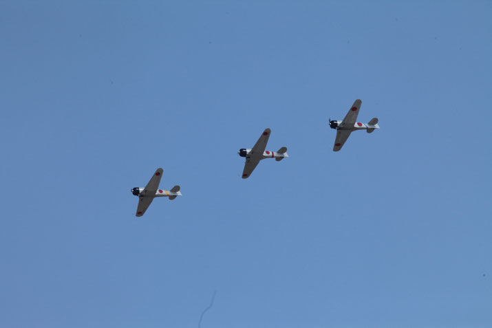 Japanese Zero fighter planes in blue sky