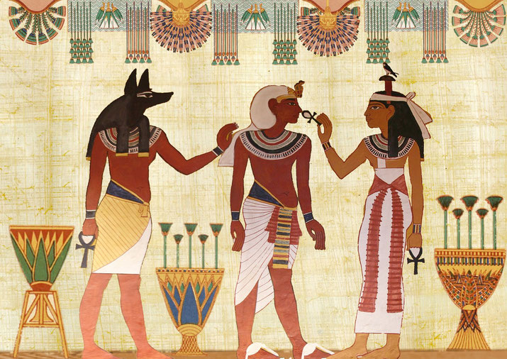 Ancient Egyptian wall art depicting Anubis, a central figure, and a female deity holding an ankh, with decorative symbols and motifs in the background.