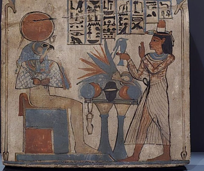 An ancient Egyptian painting of a woman offering to Ra-Horakhty, seated with a falcon head and sun disk. Hieroglyphs, ritual items, and vibrant colors highlight the religious scene.