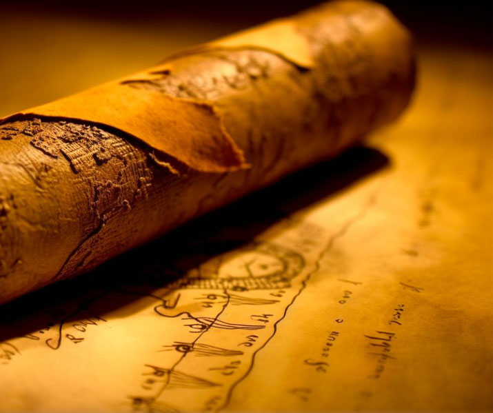 An ancient, weathered scroll resting on a parchment with faded script and drawings. The warm lighting highlights its aged texture, evoking a sense of mystery and lost knowledge.