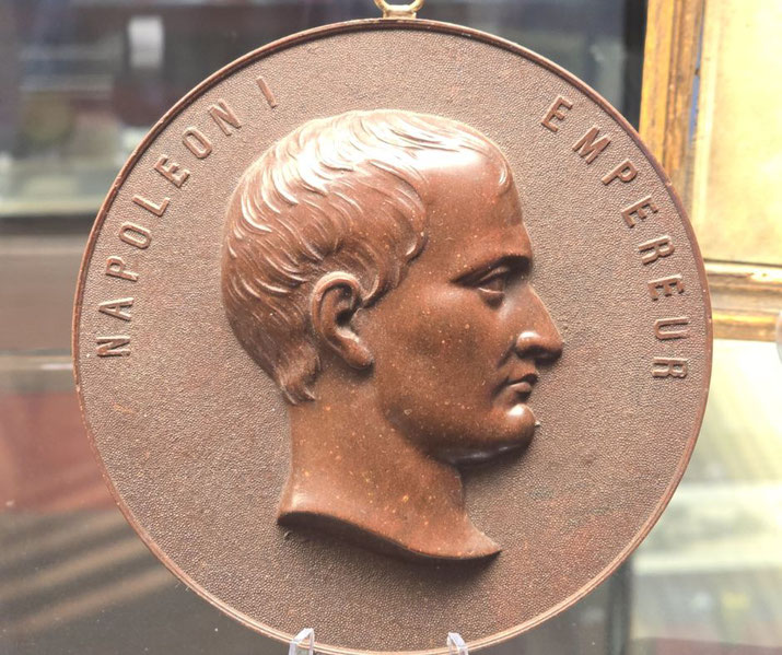 Emperor NapoleonaBronze medallion featuring a right-facing profile of Napoleon I with the words "NAPOLEON I" and "EMPEREUR" engraved around the edge.