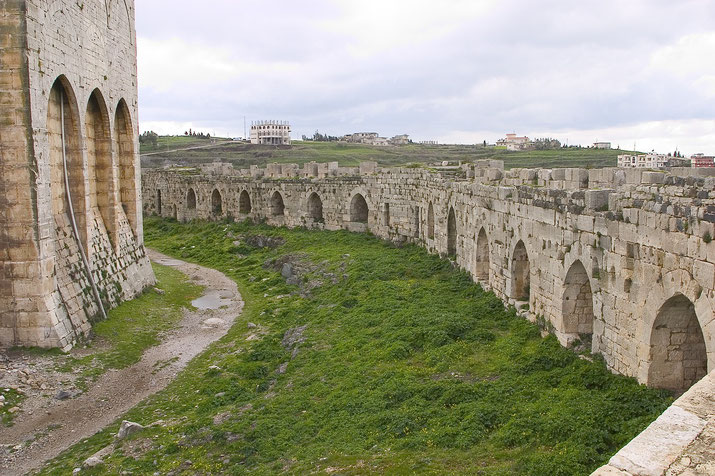 section of Krak des Chevaliers' outer walls with multiple arches.