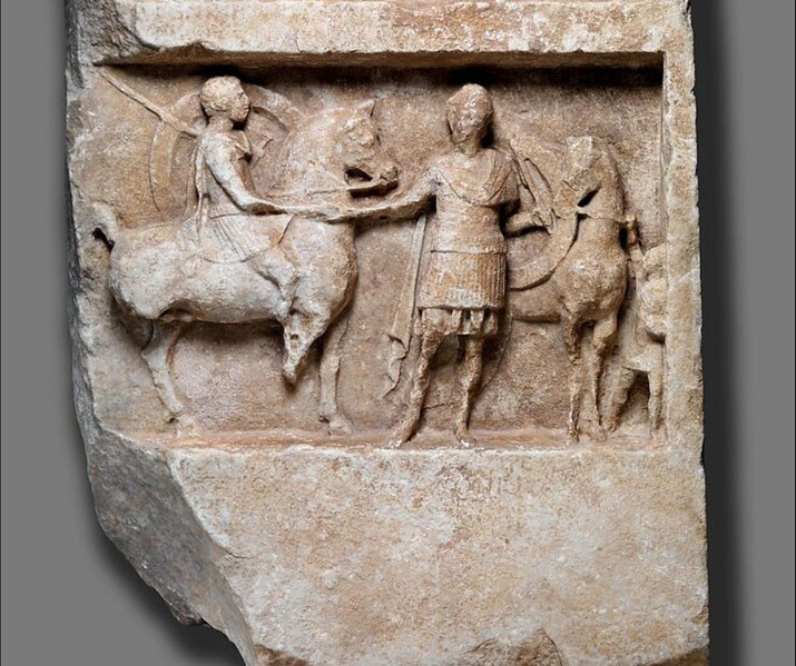 Marble relief depicting two brothers, sons of Apollonios, honored as heroes through scenes of a banquet and departure for battle.