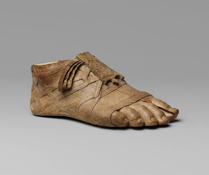 Ivory foot fragment from a Roman statue; sandal's tongue features a Nile figure, hinting at the subject's link to Egypt.