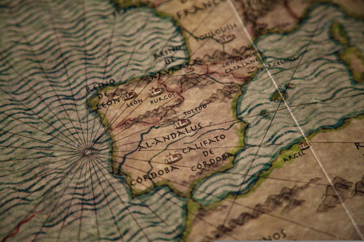 Close-up of an old map showing medieval Iberia with labeled regions like Al-Andalus, Córdoba, León, and Navarre.