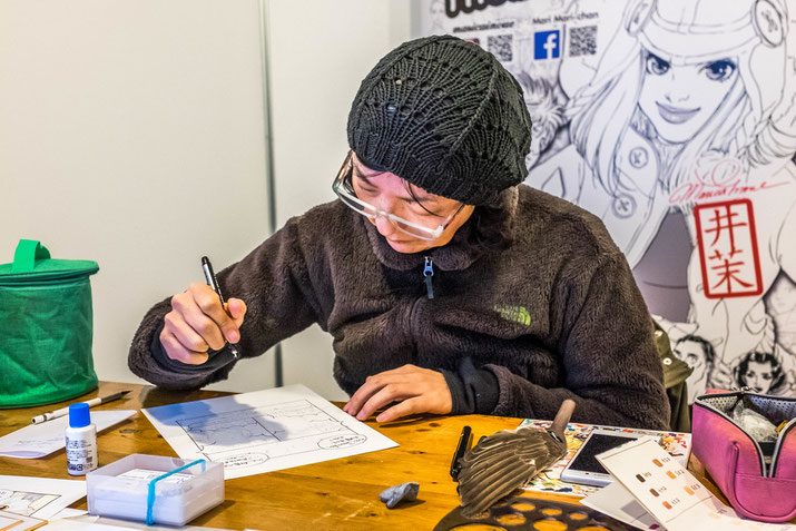 A short manga in the making: Mari Mari Chan takes our portrait while we watch wide eyed.