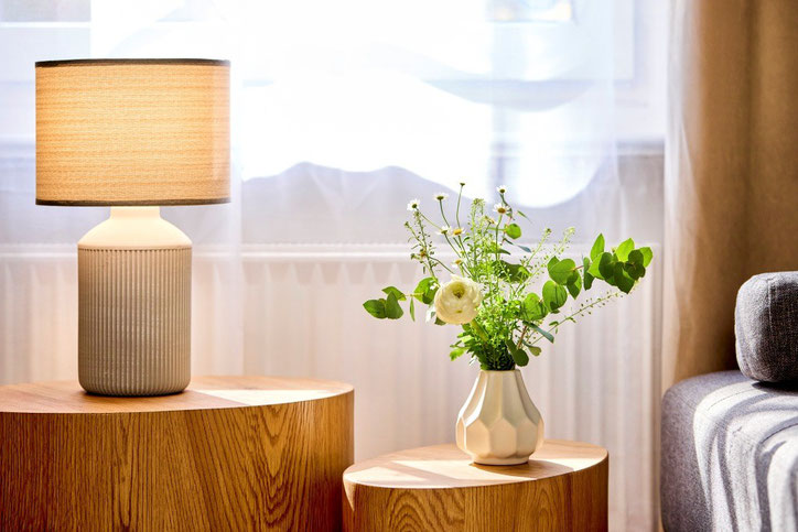 Ruheoase in Lübeck: Auf dem Bild ist eine Lampe und ein kleiner Blumenstrauß in einer Vase zu sehen. Es herrscht eine harmonische Stimmung zur Entspannung. Sie hilft beim Abbau von Stress.
