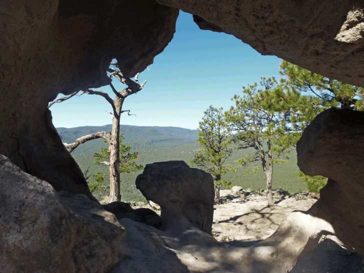 A natural rock window on Stable Mesa. The outcrop features petroglyphs and, unfortunately, modern graffiti.