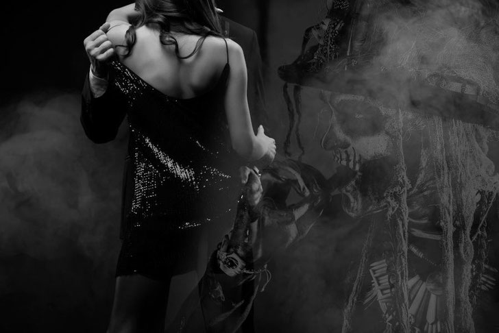 voodoo ritual elegantes paar in rotem nebel mit baron samedi in hintergrund