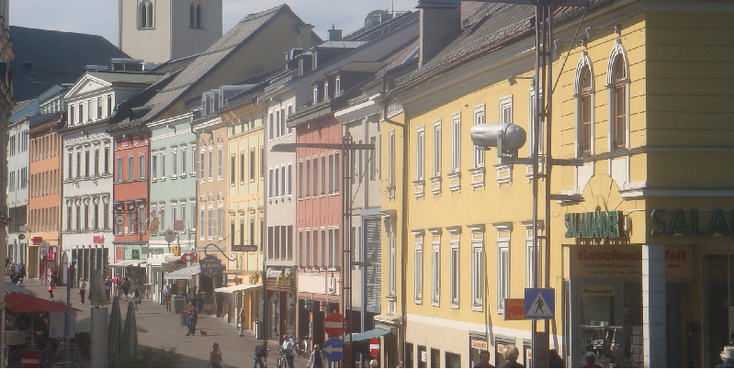 Villach-winkelstraat-St-Jacobs-kerk-gekleurde-woonhuizen-Oostenrijk