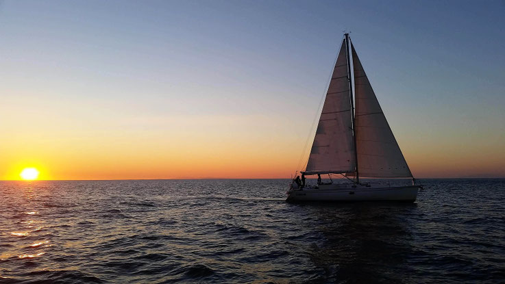 Sailing at sunset - White Wake Sailing