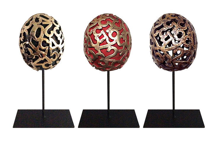 Eggs sculpture series by Paolo Grassi in patinated bronze, each with numeric engravings symbolizing origin and transformation.