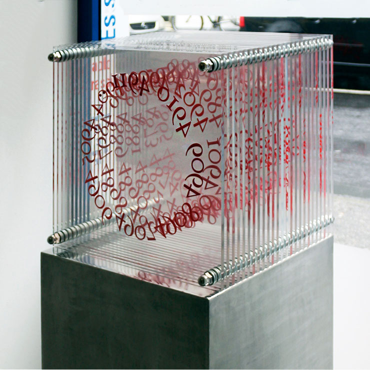 paolo-grassi-numeric-cube-conceptual-sculpture-indoors – plexiglass sculpture with concentric red numbers, conceptual art with geometric depth