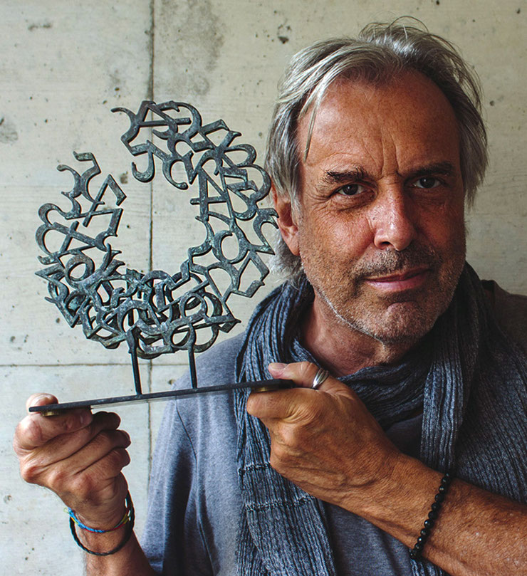 Paolo Grassi, Swiss conceptual artist, with the bronze sculpture Love from the project From "0" to Infinity