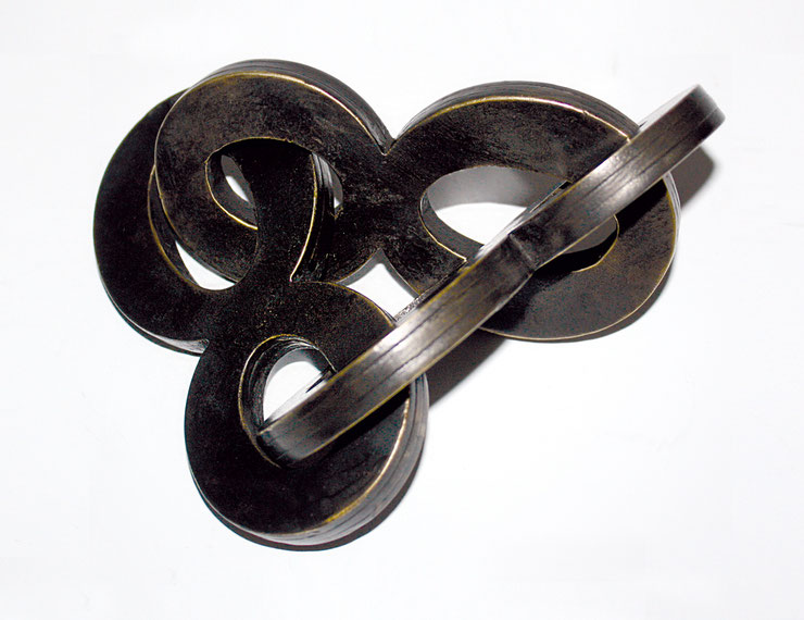 Close-up of bronze sculpture "888" by Paolo Grassi showing interlocking numeric shapes in dark patina