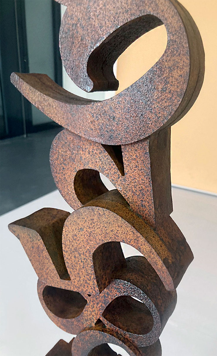 close-up of corten steel number sculpture by paolo grassi with textured surface and shadows