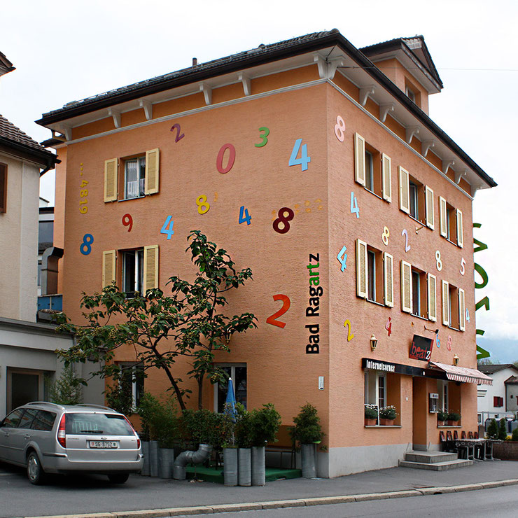 Side angle of the 2012 numeric facade sculpture by Paolo Grassi at Bad Ragartz