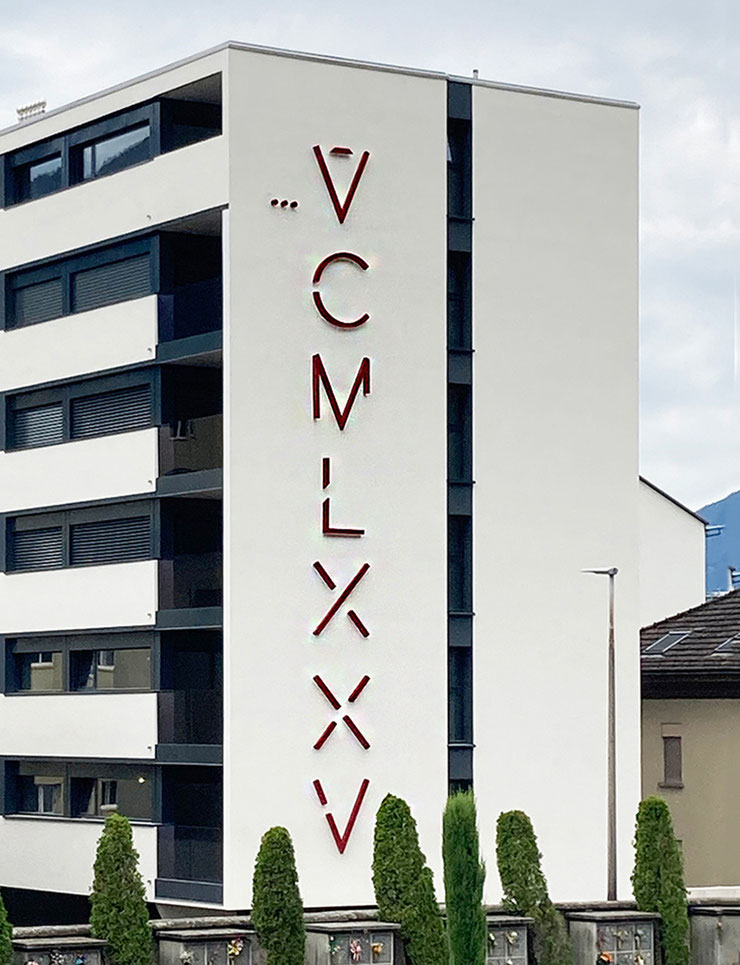 Paolo Grassi’s VCMLXXV installation on a residential building facade in Locarno, with cemetery in the foreground.