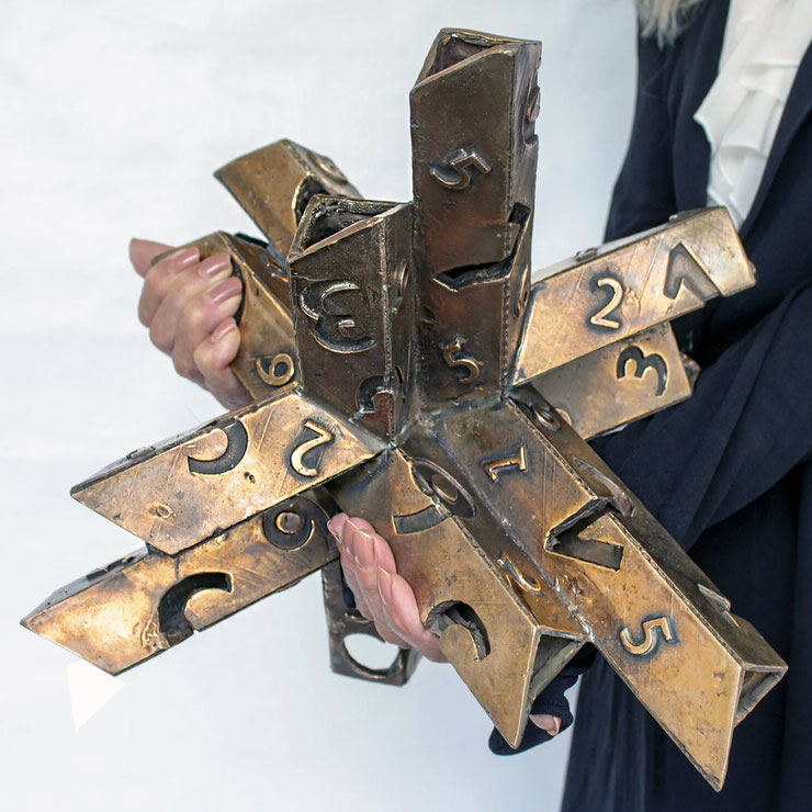 Paolo Grassi holding the bronze sculpture Rigoberta, a unique numbered artwork from the conceptual project From "0" to Infinity