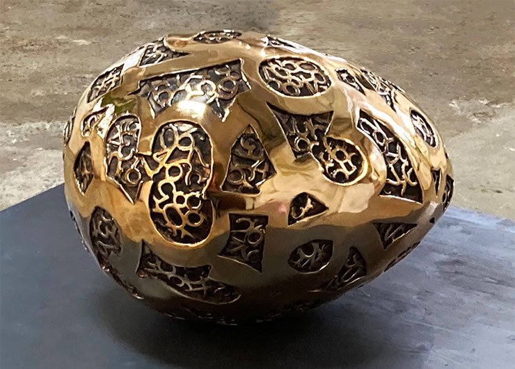 big egg sculpture closeup patinated bronze surface numbers paolo grassi