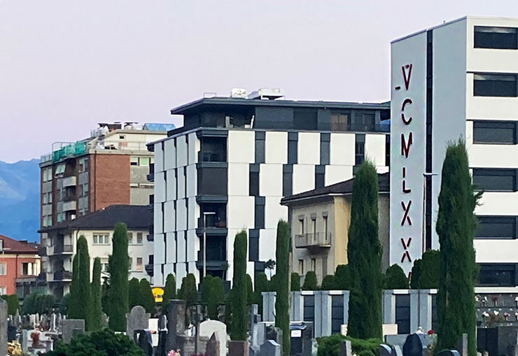 Panoramic view of Paolo Grassi’s VCMLXXV installation in Locarno, rising beyond the cemetery toward the city.