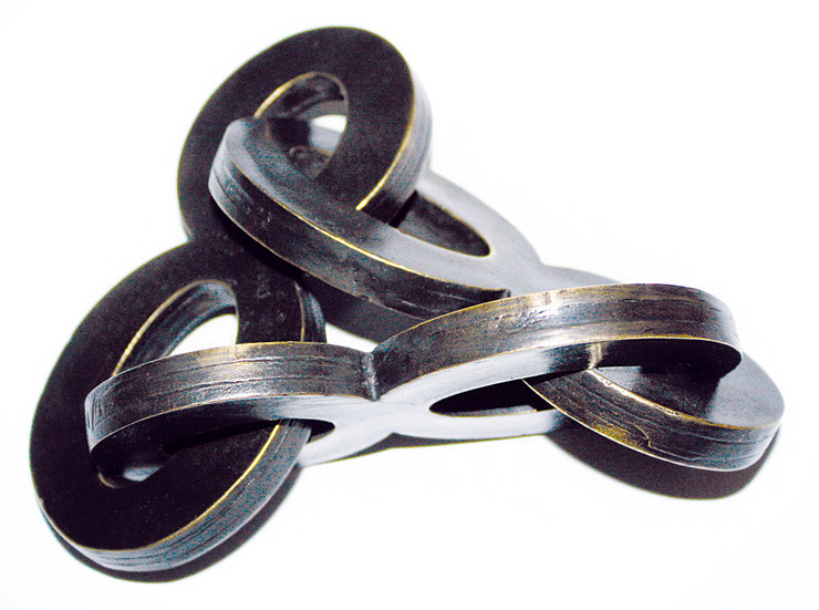 Top angle of Paolo Grassi's "888" sculpture revealing overlapping bronze eights with strong conceptual balance