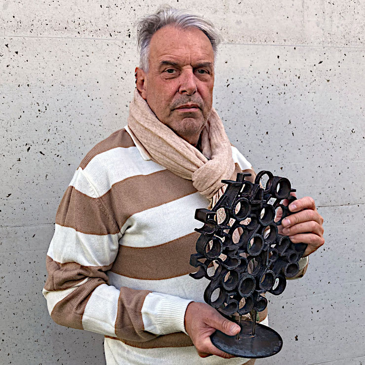 Paolo Grassi, Birba bronze sculpture from the project From ‘0’ to Infinity, shown in the artist’s hands to reveal scale, texture and numerical composition.