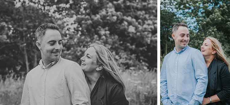 A couple laughing with each other in the woods