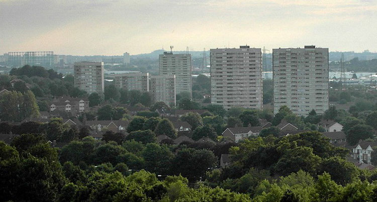 The blocks of flats on the Bromford estate; the low-rise houses among the trees in the foreground are on the Firs estate. In the distance can be seen the Dudley hills.