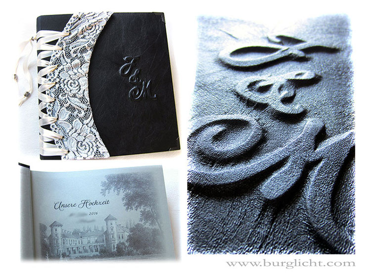 Hochzeitsalbum, Hardcover-Bucheinband mit Flachrelief Monogramm, Bucheinbandmaterial Stoff schwarz, Korsett aus Spitzenstoff naturweiß und Satinband hellcreme, Vorsatz individuell bedruckt, Metall-Buchecken schwarz, 30x30cm, 50 Blatt schwarz.