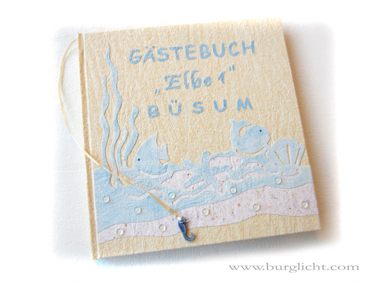Maritimes Gästebuch Ferienwohnung, Strukturpapiere sand blau meliert, Leseband mit Seepferdchen, Kunststoff-Halbperlen transparent, 25cm x 25cm, 200 Seiten weiß.