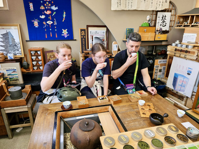 Guests tasting Japanese green tea brewed at different water temperatures during a tea experience in Fuji City