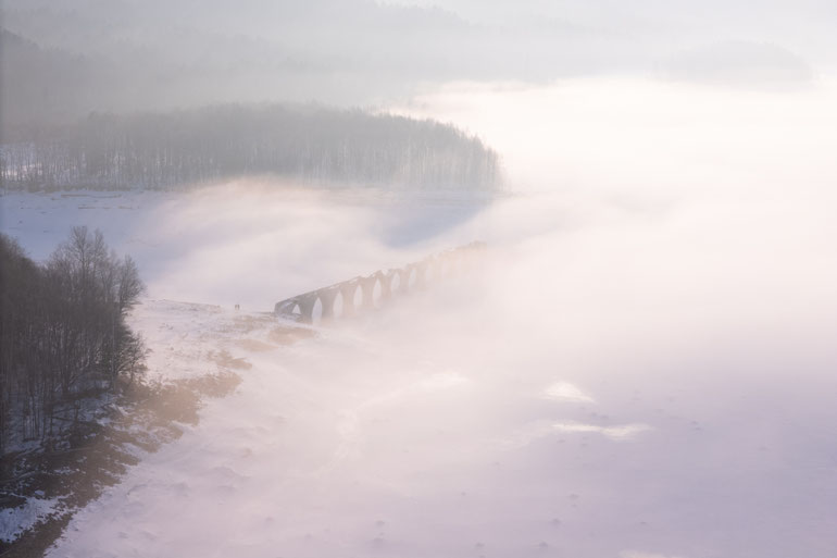 2026 — The bridge enveloped in winter morning mist, illuminated by the rising sun.