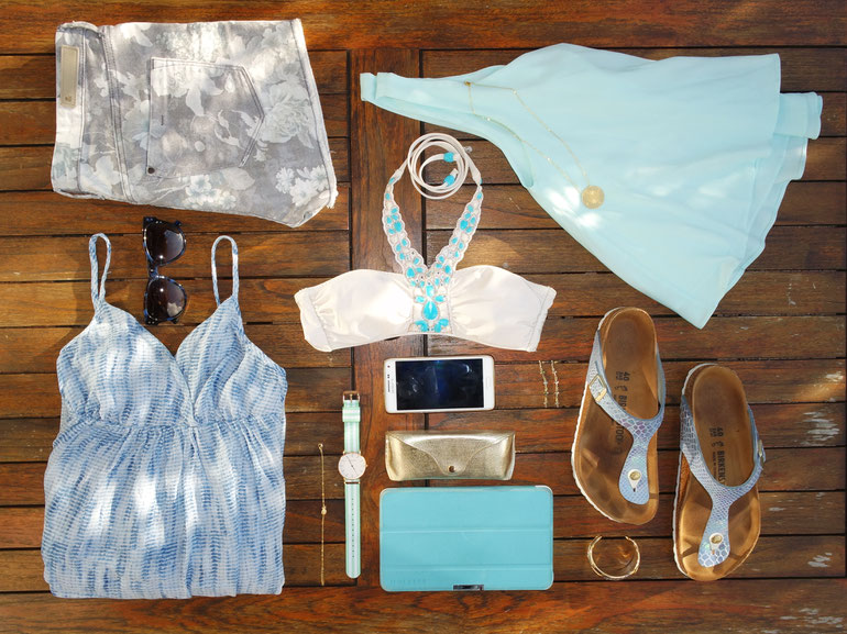 Flatlay of blue clothes and accessoiries