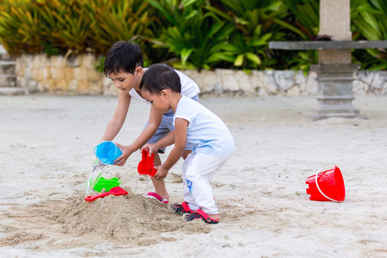 Simple picture of my 2 boys playing together in the sand, natural behavior photo