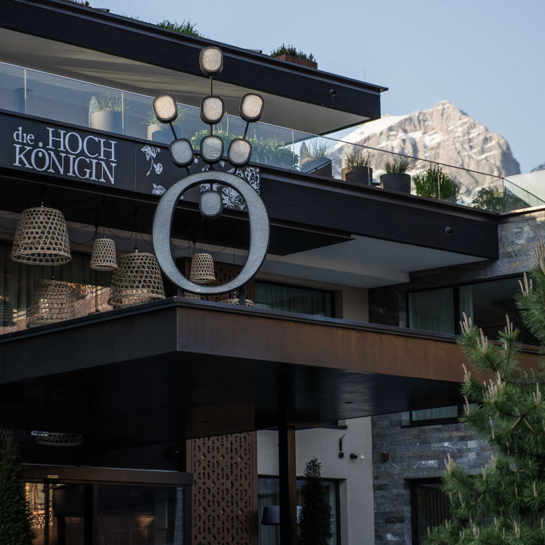 The modern entrance area of the Hochkönigin Wellness Hotel in Maria Alm, Salzburg, with views of the mountains