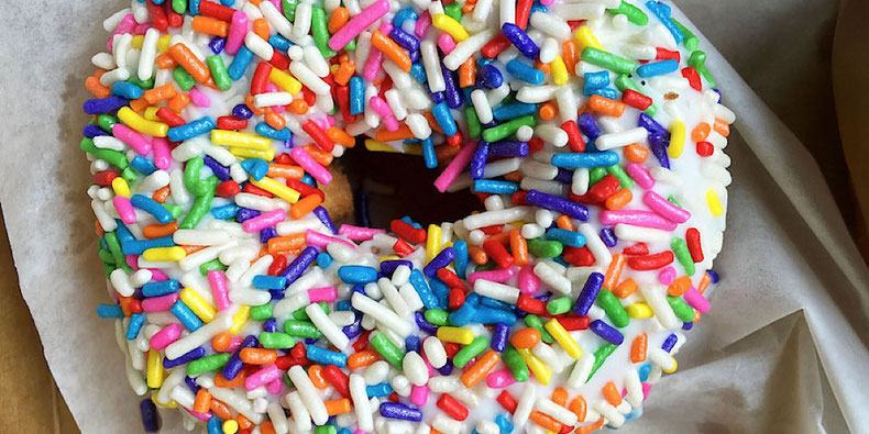 vegan rainbow sprinkle doughnut from voodoo doughnut in portland oregon