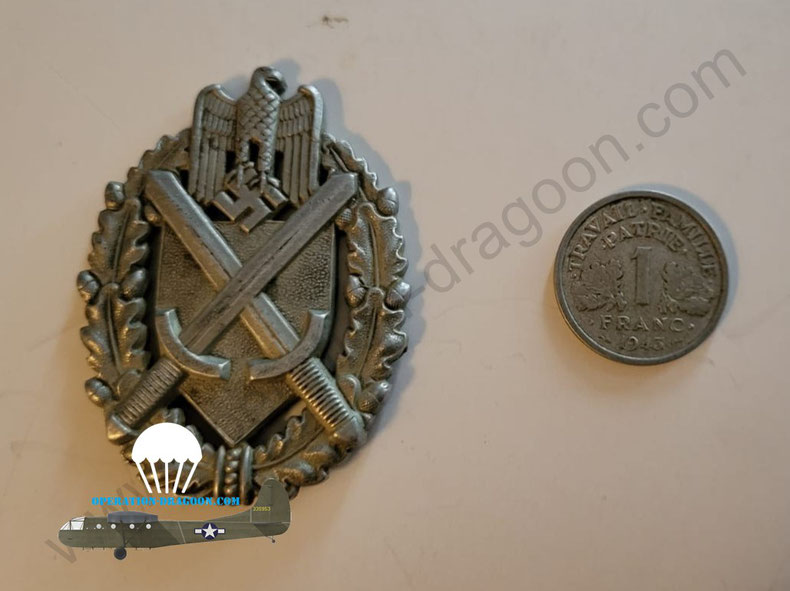 "souvenir" from the war, German riffle shooter insignia and a french 1943 vichy government coin. Courtezy T.DUBAY