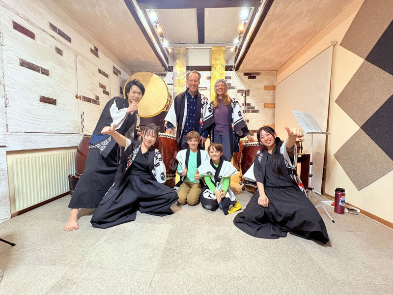 Foreign tourist enjoying traditional Japanese Taiko drumming experience in Hokkaido near Sapporo