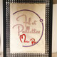 Sur l'image, un tableau réalisée en broderie avec le logo de Fil et Paillettes fait main.