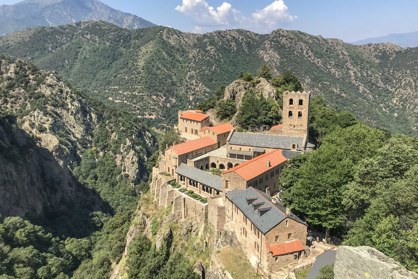 Abbaye Saint-Martin-du-Canigou surrounded by beautiful forests and mountains.