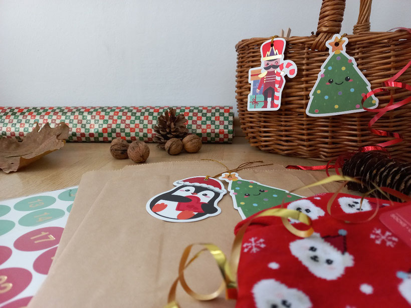 Zahlenaufkleber, Papiertütchen, Geschenkpapier und weitere weihnachtliche Dekoration für einen selbst gestalteten Adventskalender für Kinder