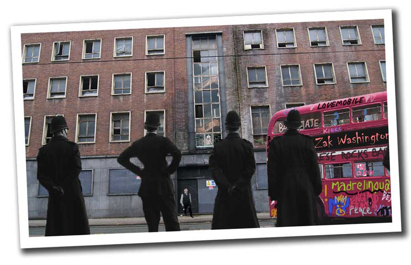 derelict building with British double decker bus and a row of policemen ZakWashington Learn English language free online