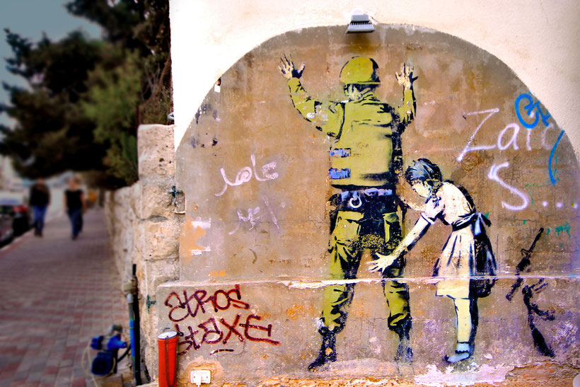 The British graffiti artist Banksy visited the West Bank in 2005 and painted several images along the separation wall and in the town of Bethlehem. © Sabrina Iovino | JustOneWayTicket.com