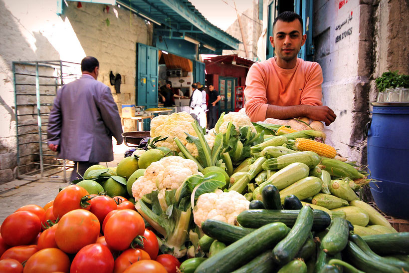 A young man selling veggies in the streets of the Old City of Nablus, Northern West Bank. © Sabrina Iovino | JustOneWayTicket.com