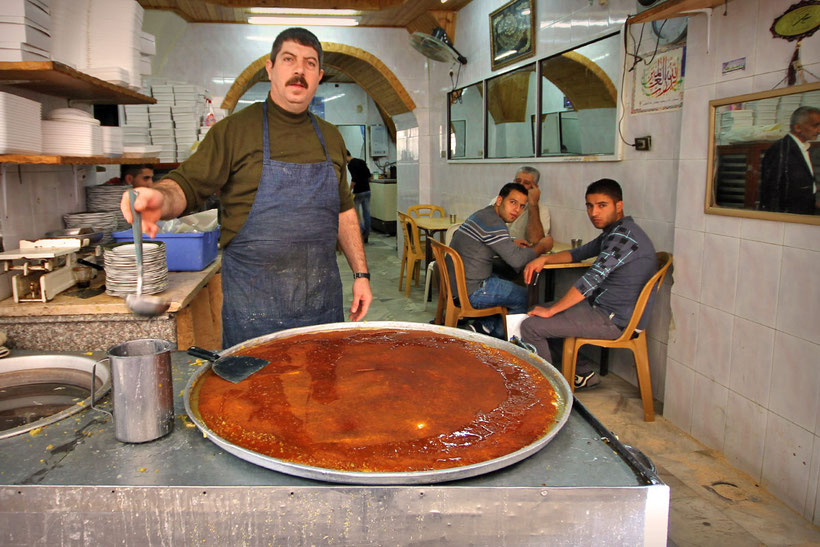 Knafeh (also spelled as Kanafeh or Kunafeh) is a delicious cheese pastry, soaked in sugar-based syrup with melted goat cheese on top. © Sabrina Iovino | JustOneWayTicket.com