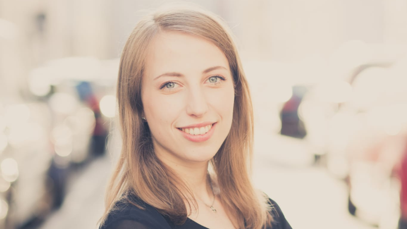 Portrait Hobbykünstlerin Andrea Niebler, sie lächelt in die Kamera, schulterlange blonde Haare, schwarzes Kleid