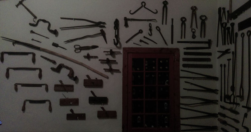 Red wine storage, old tools on the wall of the bar, South AFrica.