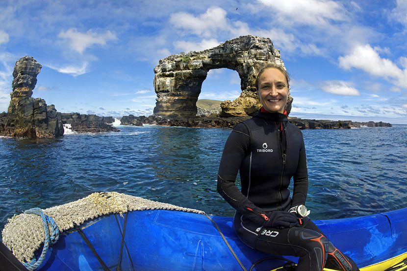 Jenny Waack from Galapagos Shark Diving sitting in a Zodiac in front of Darwin's Arch in the Galapagos Islands; ©Jonathan R Green